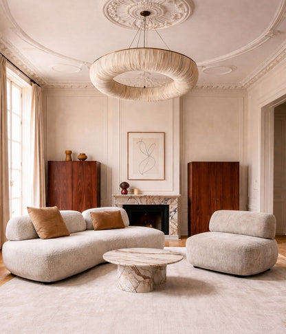 Modern living room with a Almond sofa, armless armchair, and marble coffee table Miami design
