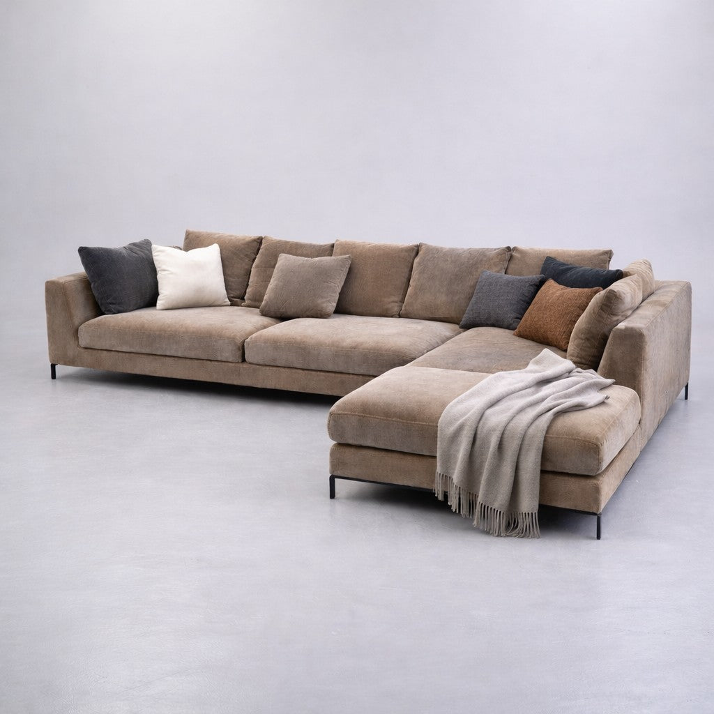 Beige sectional sofa in Miami and a blanket on a light gray background