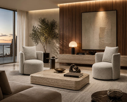 Modern living room with beige gray swivel arm chairs, a modern coffee table, and contemporary decorative items.