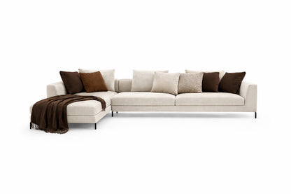 White chenille  sectional sofa with brown cushions and a blanket designer aesthetics 